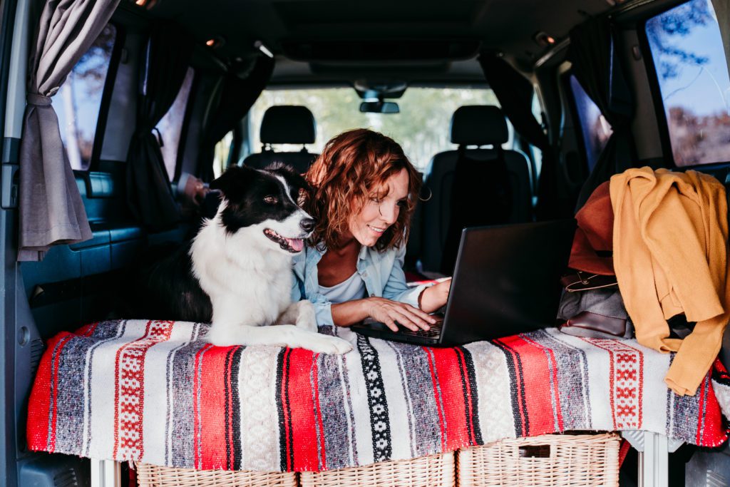 woman and dog in back of van