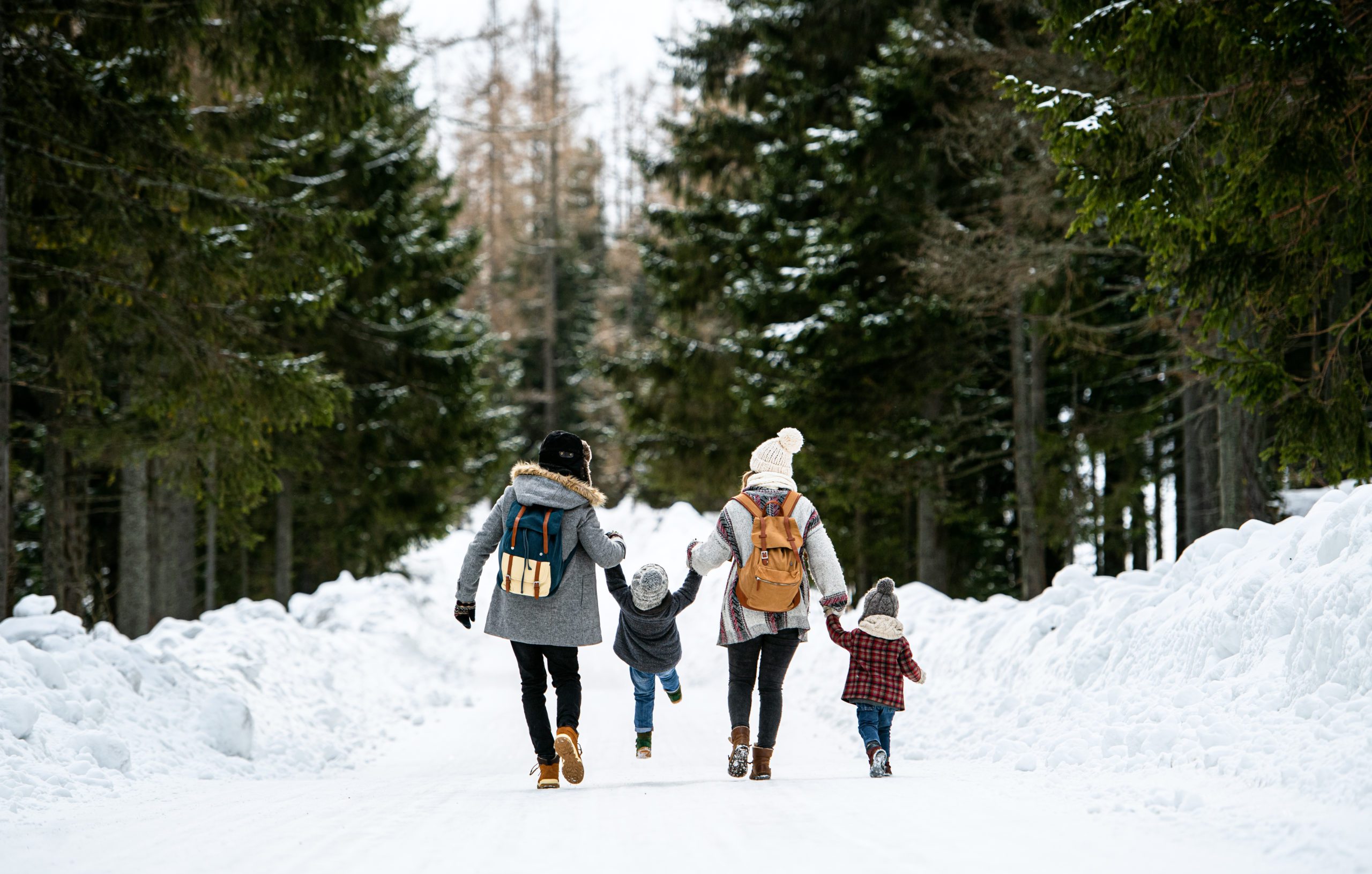 family walking on snowy path